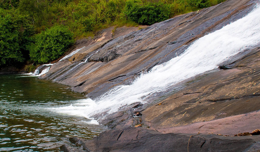 Galpoththa Falls, also known as Sudugala Falls, is a unique natural water slide in Nawalapitiya. Unlike traditional waterfalls, its waters gently glide over a slanted rock bed, creating a serene and calming flow. Standing over 50 meters tall and 60 meters wide, it ends in a shallow, refreshing pool, making it a popular bathing spot. A scenic walk through a pine forest leads to the falls, offering a peaceful retreat surrounded by nature’s beauty.